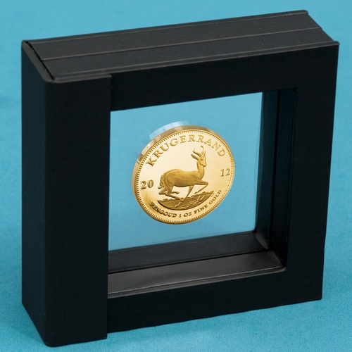 Gold and silver coins float in designer frame
